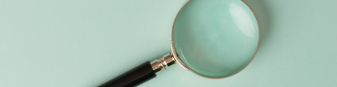 Baker's Gas Magnifying glass on light blue table