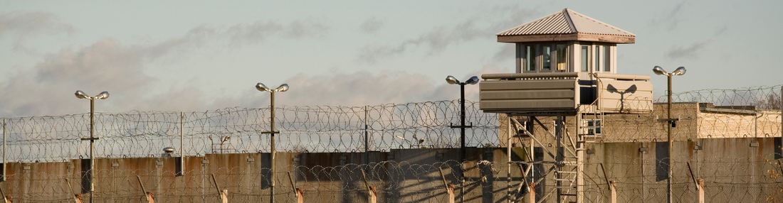 Prison tower and barb-wire wall