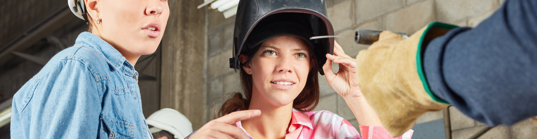 Woman wearing welding helmet