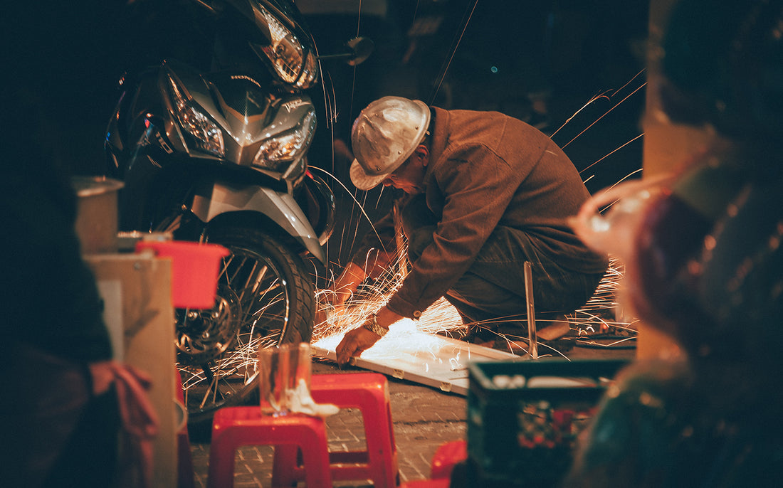 welder working on motorcycle