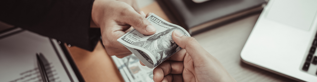 Person handing another person money